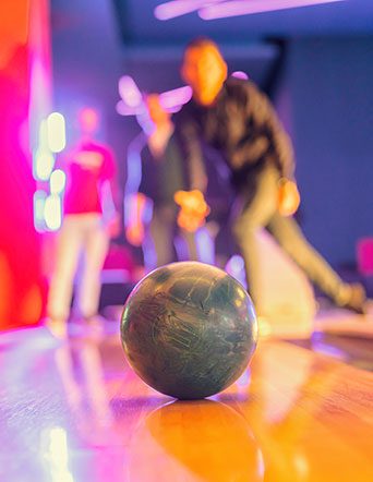 duckpin bowling ball rolls down a lane