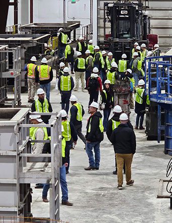 people mill about in precast plant