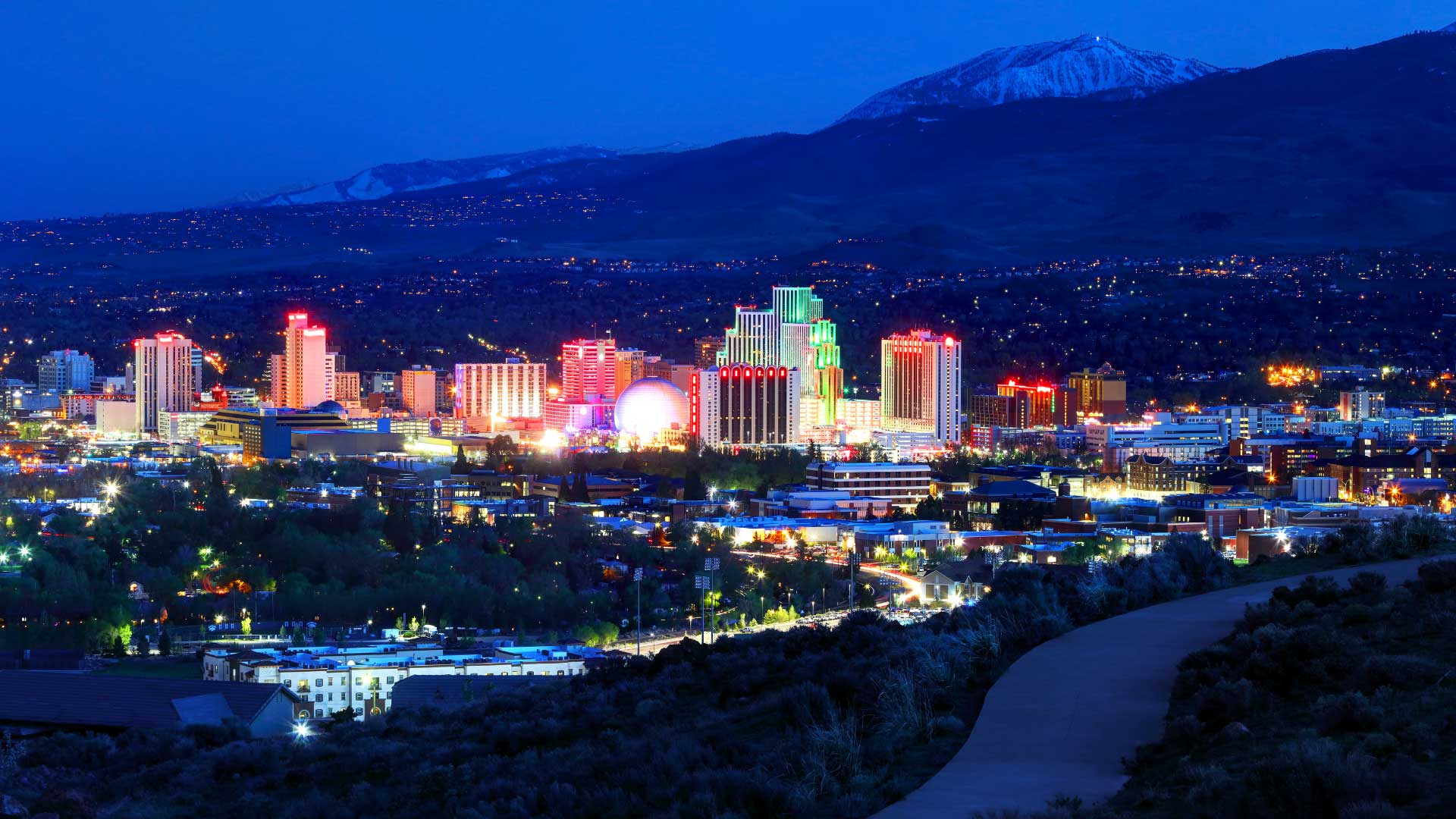 Nightime skyline in Reno, Nevada, with mountain in the background