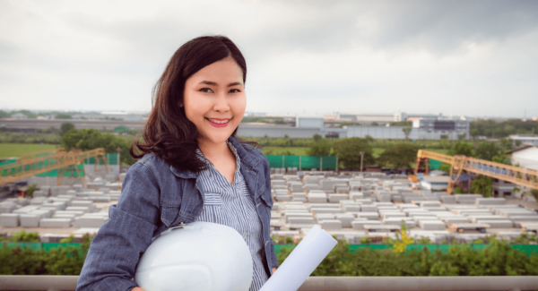Woman smiling in front of construction site