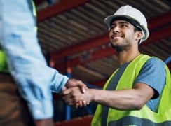 Construction workers shaking hands
