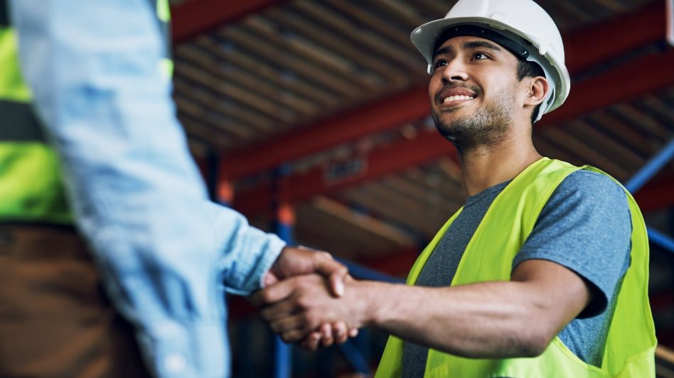 Construction workers shaking hands