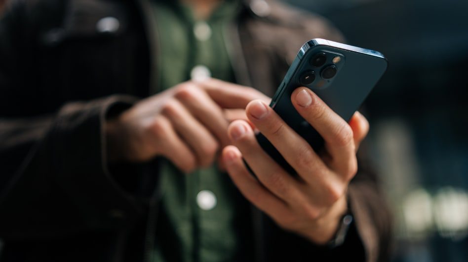 Close-up of hand holding mobile phone