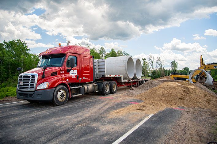truck carries culverts produced by county materials