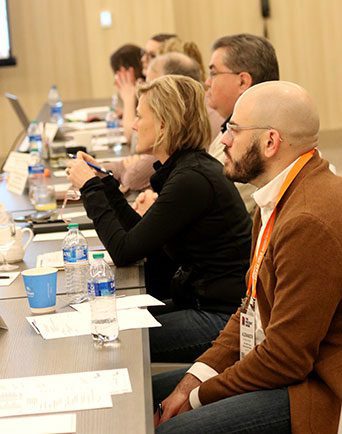 people discuss topics during a committee meeting