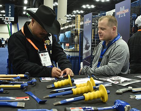 two men talk on The Precast Show floor