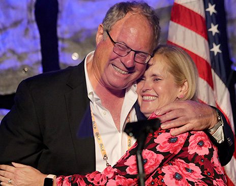 A man and woman embrace after the woman was named the Robert E. Yoakum Award winner.
