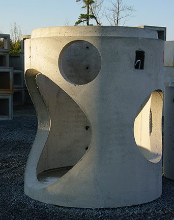 A catch basin sits in a precast concrete yard.