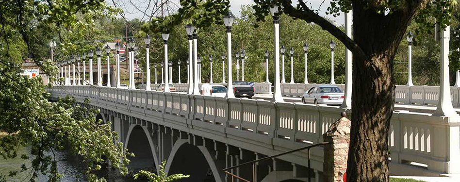 Cars travel across a precast concrete bridge.