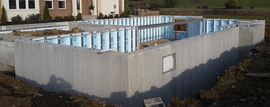 A precast concrete foundation is nestled in the ground.