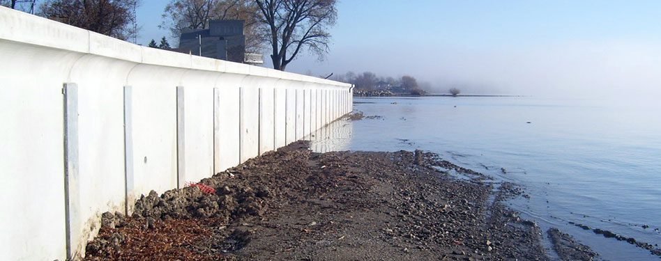 A precast concrete wall protects the shore.