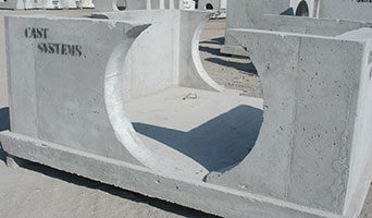 A large precast piece rests in a yard.