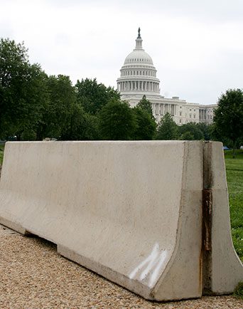 Precast concrete barriers sit in front of the U.S. Capitol building.