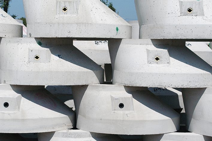 Precast concrete manholes are stacked on top of each other.