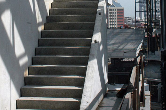 Precast concrete steps are positioned inside a building.