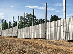 Concrete wall along a dirt road