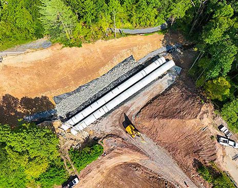 Aerial view of construction site with concrete pipes laid out